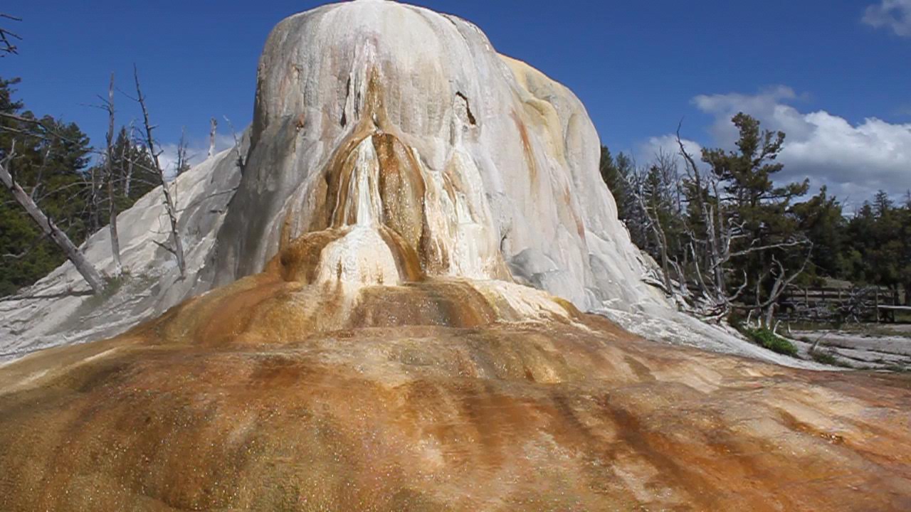 rock formation with water flowing off of it