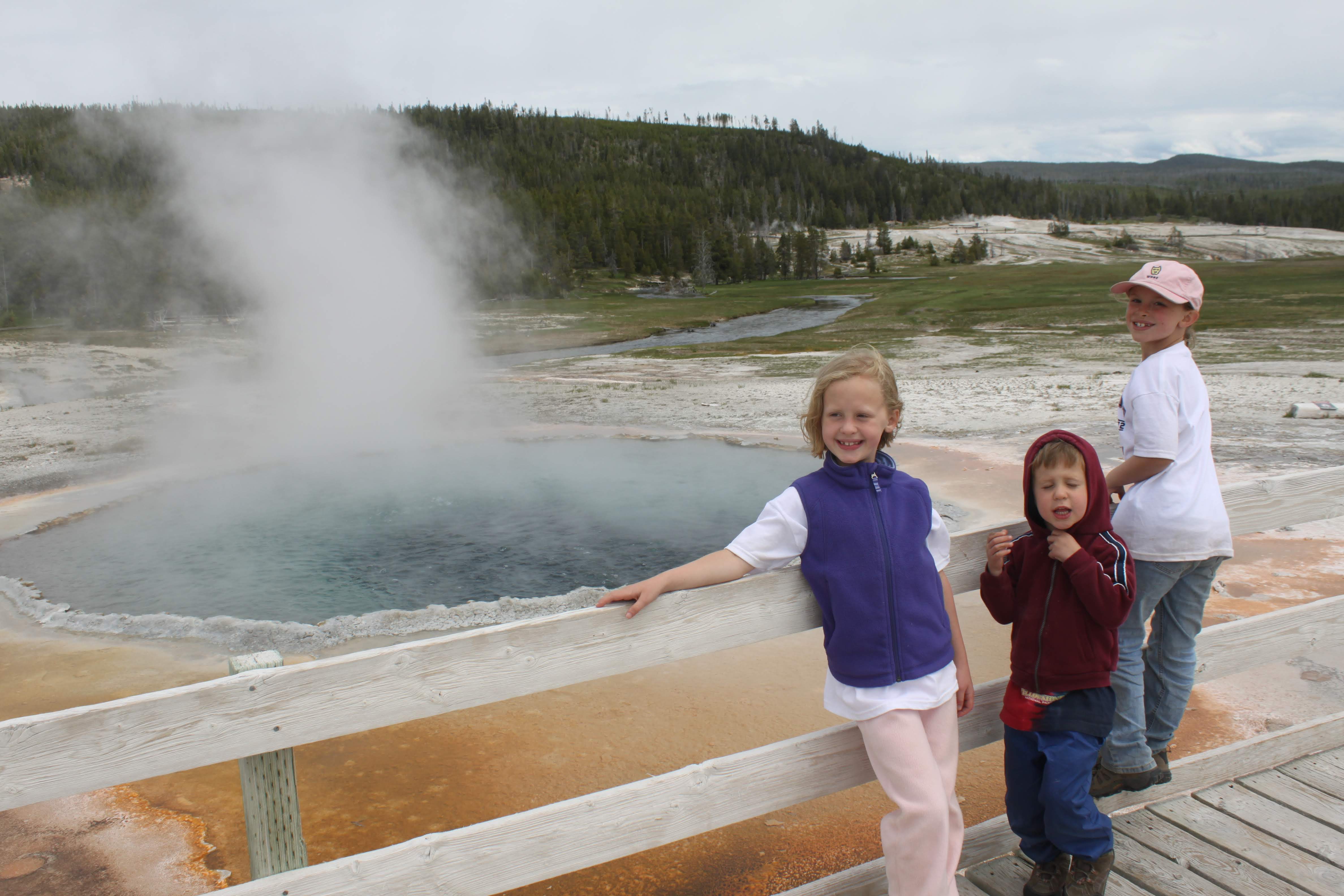 People in front of bubbling hot pool